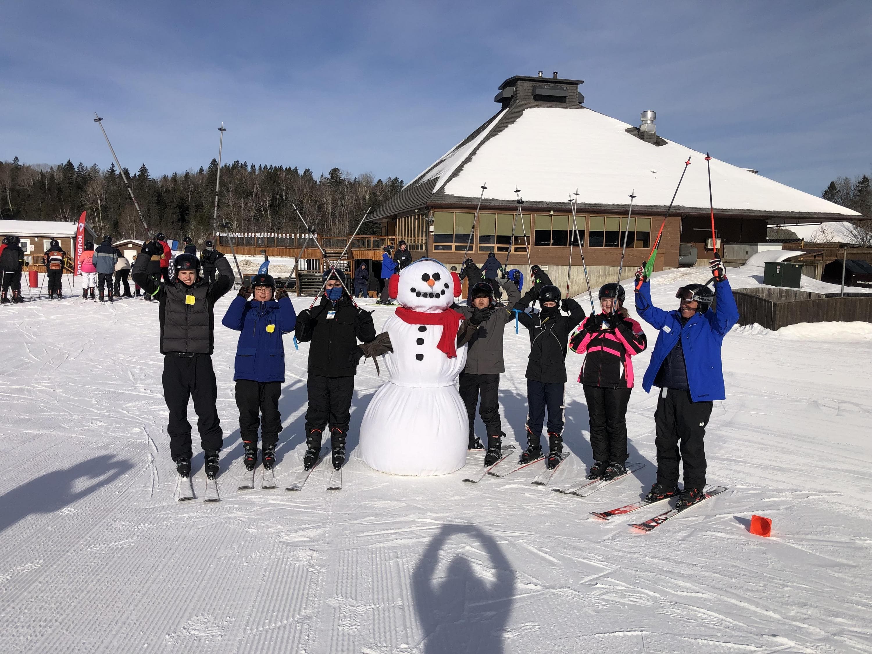 Hero image for SnoFest website of skiers on top of mountain