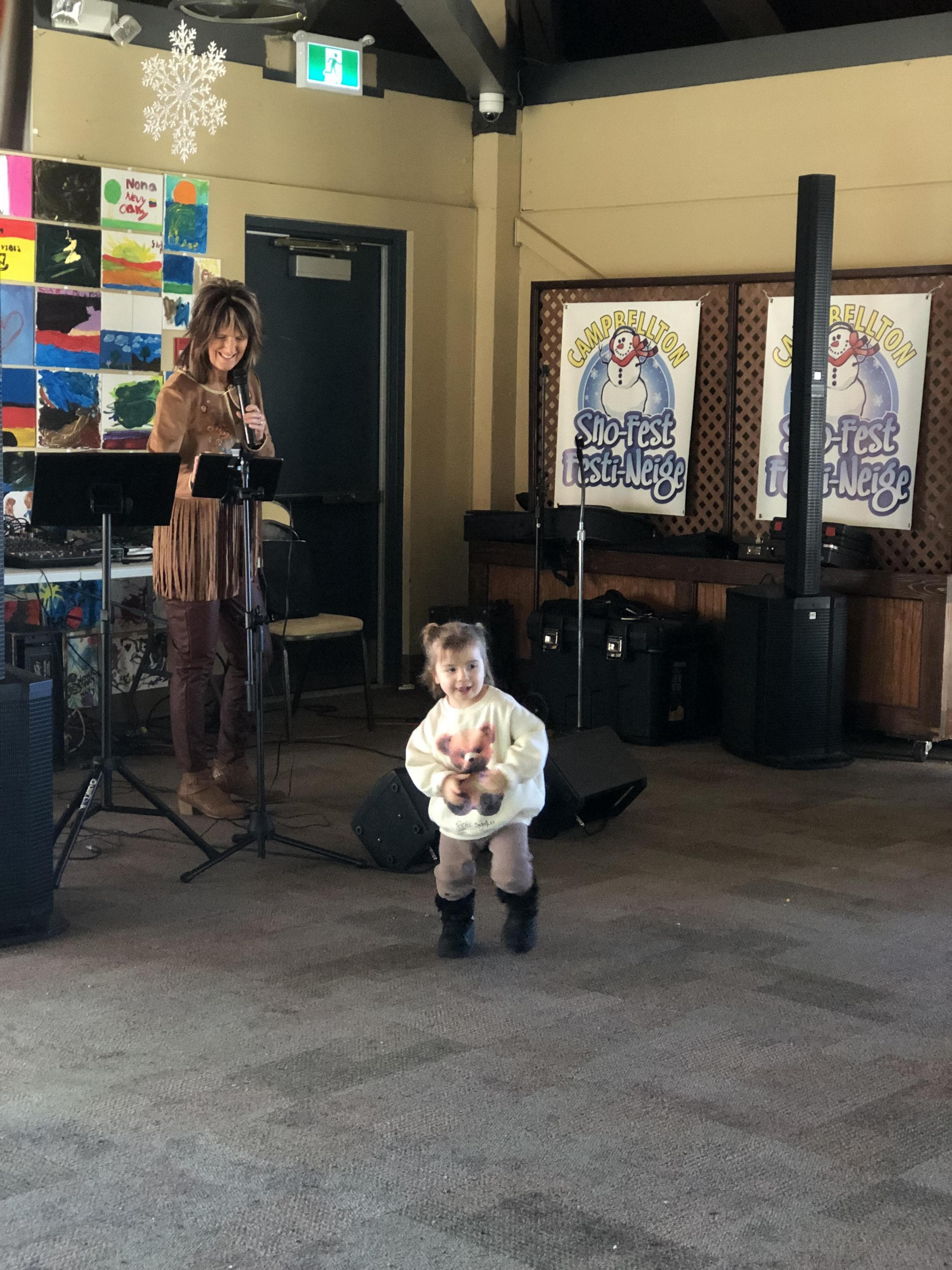 Live music stage at Sno-Fest Village, with an audience enjoying a concert